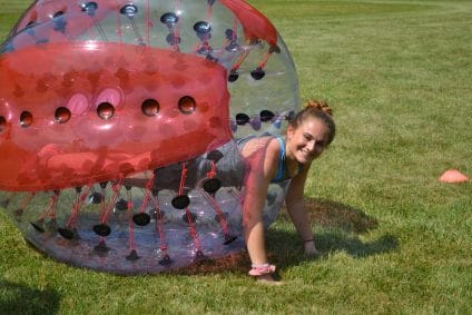 girl at summer camp in zorb