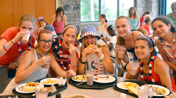 girls at summer camp eating breakfast