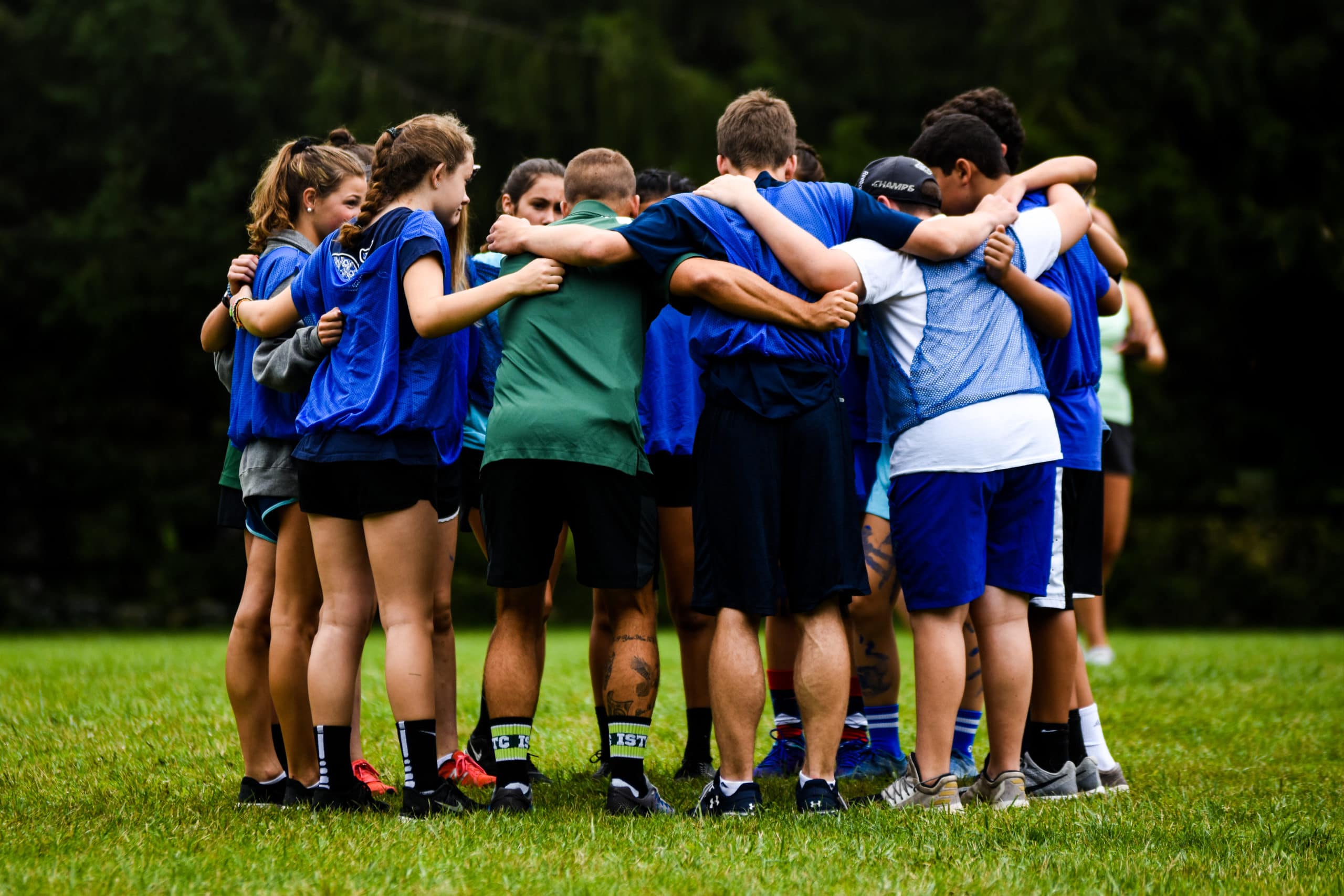 group huddle of sports campers