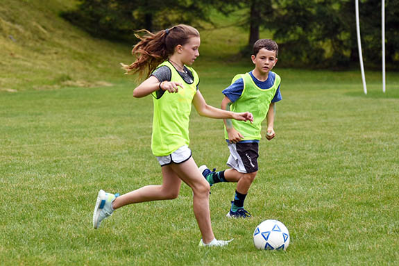 boy and girl playing soccer