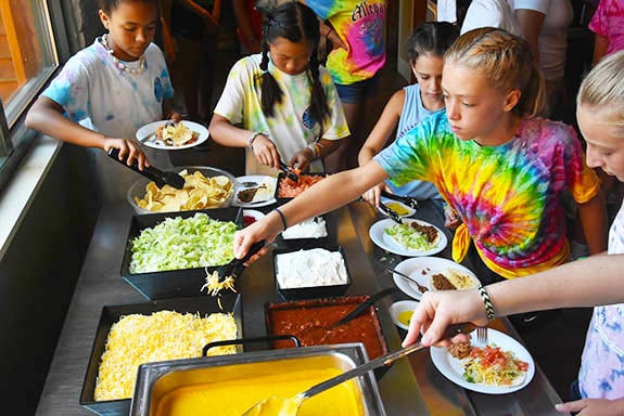kids getting food at summer camp