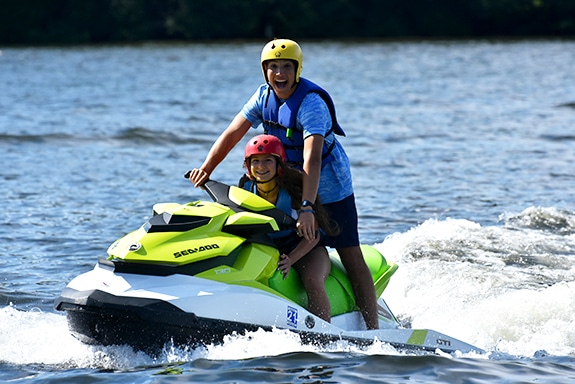 girl and counselor using jet ski